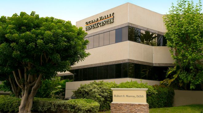 Ocean Valley Dental Center building exterior – Dentist Aliso Viejo Modern exterior of Ocean Valley Dental Center surrounded by trees and greenery, showcasing the clinic’s professional setting – Dentist Aliso Viejo