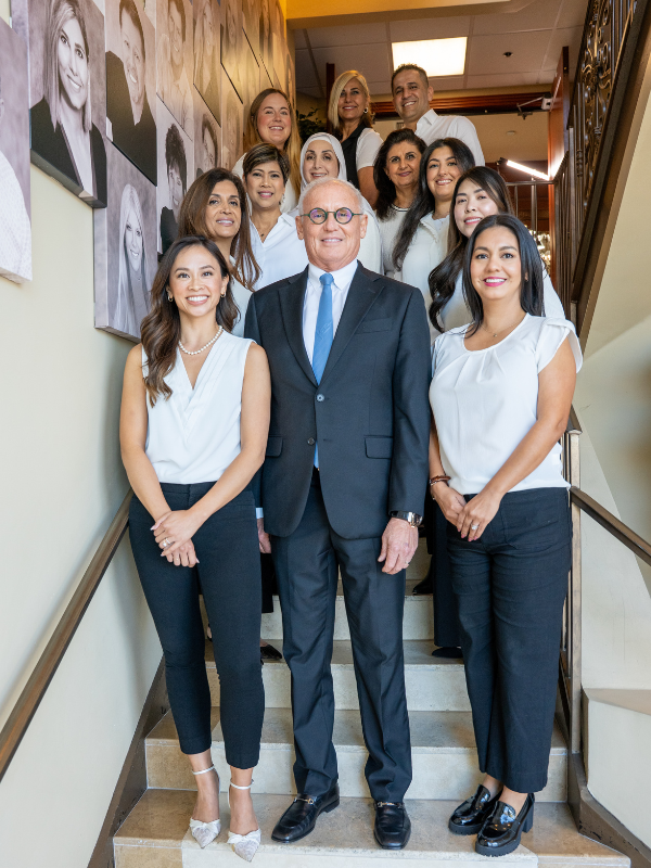 Happy dental team at Ocean Valley Dental standing around Dr. Robert Murray.